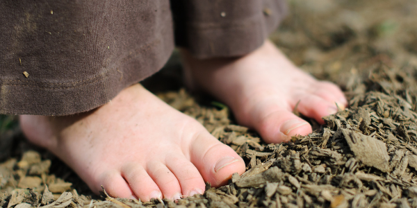 Photo of kid feet in mulch